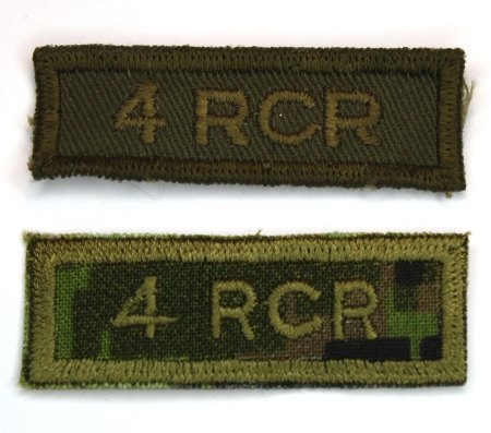 Examples of the olive drab and temperate woodland CADPAT embroidered combat tabs produced for the 4th Battalion.  neither of these were taken into general use. Photo by Capt M. O'Leary (Private Collection)