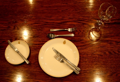 Placing the utensils to indicate you have finished the course and the staff may remove your plate.